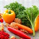 Fresh, vibrant healthy food ingredients like vegetables and fruits laid out on a kitchen counter.