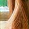 A serene woman with long blonde hair, Lisa, in her early 30s.