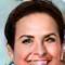 A smiling woman with short brown hair, Maria, in her early 40s.